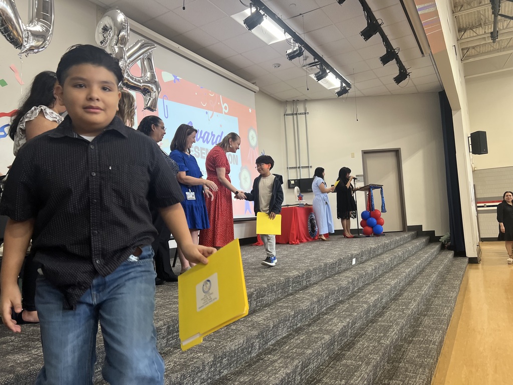 4th grade graduation ceremony with teachers on stage