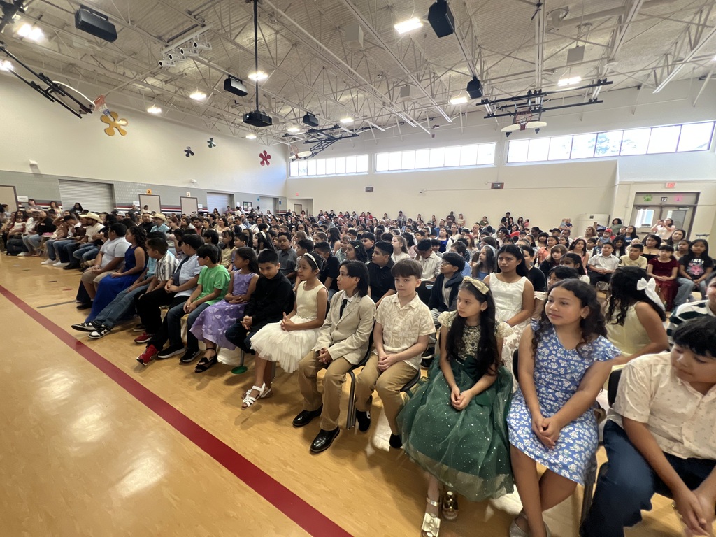 4th grade graduation ceremony with teachers on stage