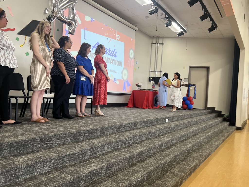 4th grade graduation ceremony with teachers on stage