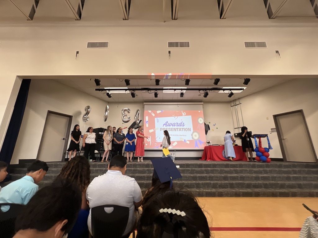 4th grade graduation ceremony with teachers on stage