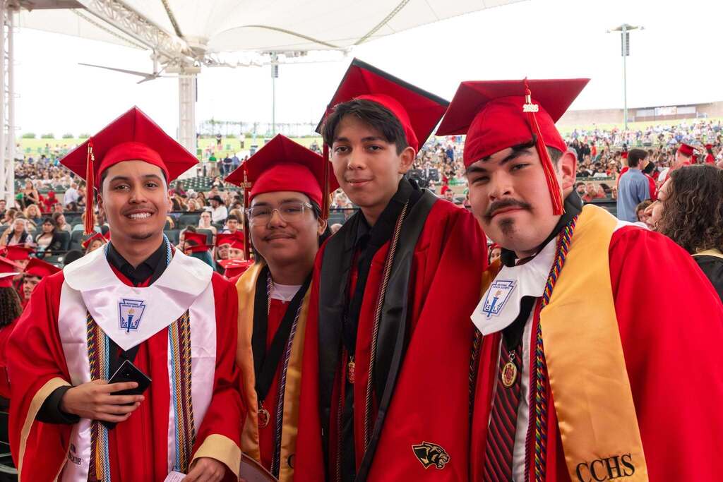 Four male students in red robes.
