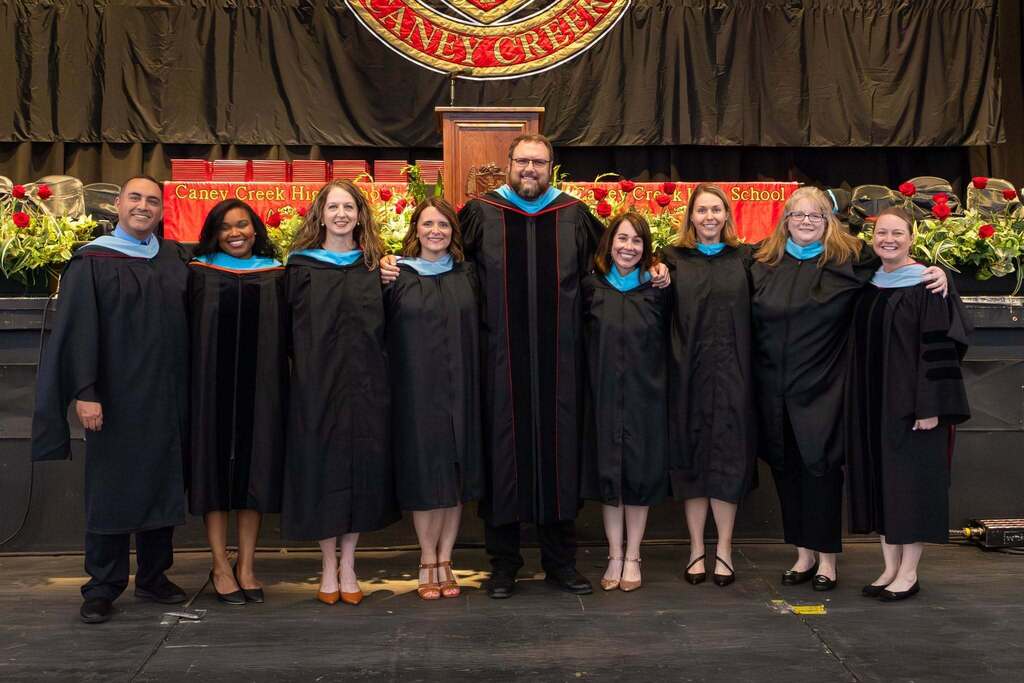 Caney Creek feeder zone principals in black graduation robes.