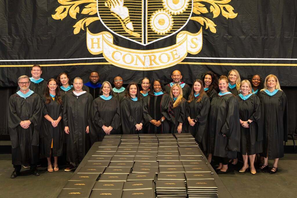 Conroe High School feeder principals in black graduation robes.
