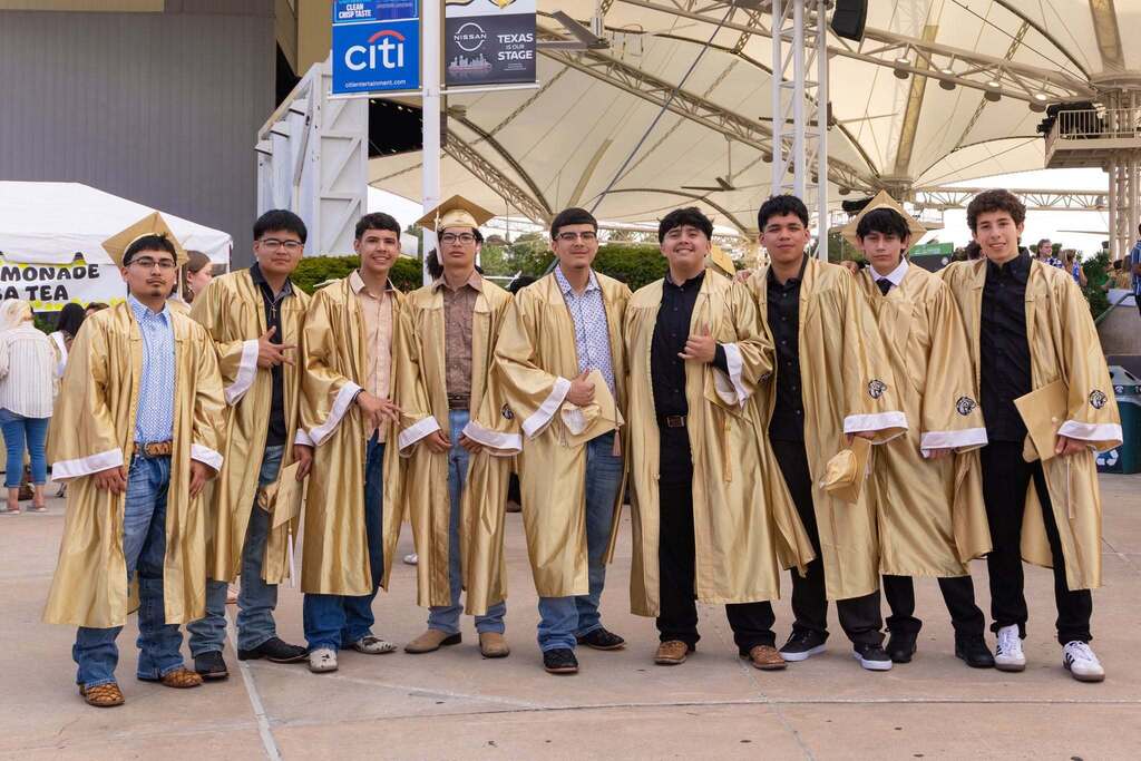 Nine male graduates in gold caps and gowns.