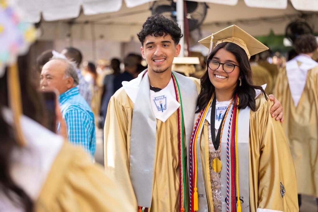 Male and female student at graduation.