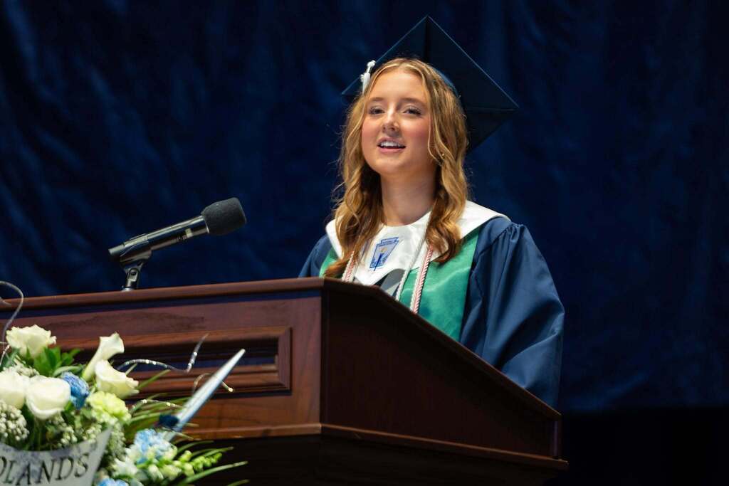 Female student gives speech at graduation.