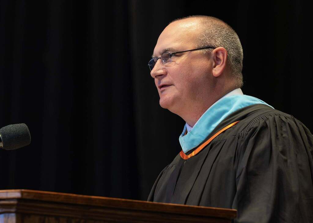 Principal gives speech at graduation.