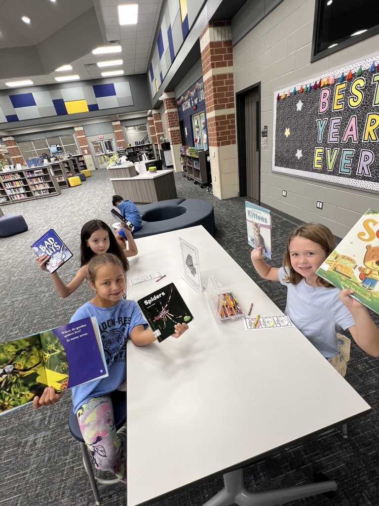 Students Checking holding books in the library