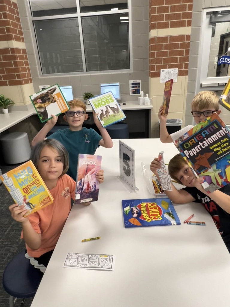 Students Checking holding books in the library