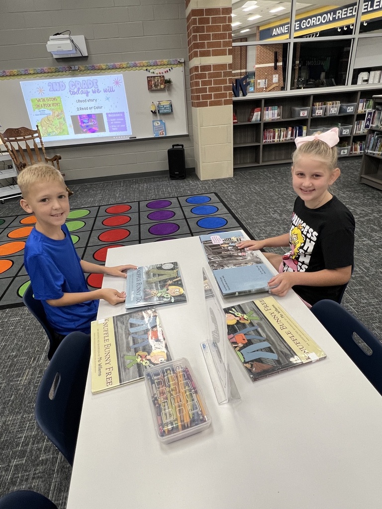 Students Checking holding books in the library