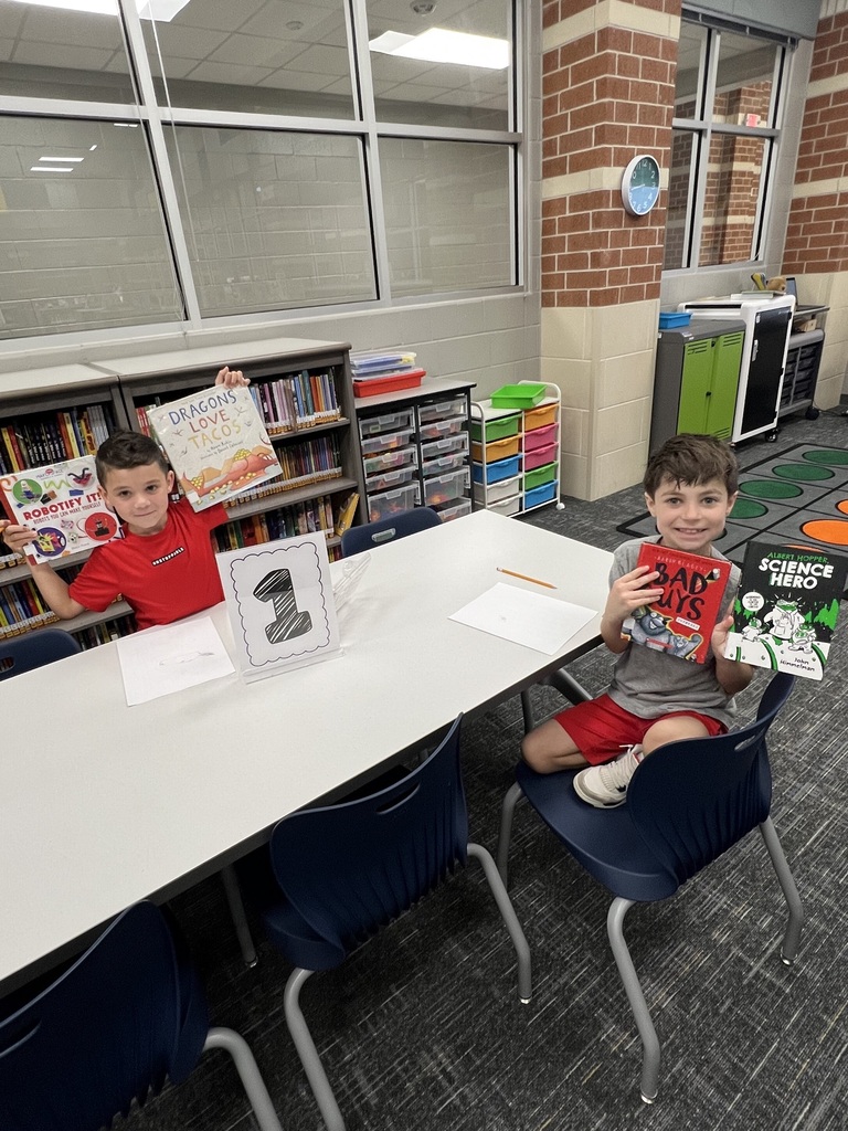 Students Checking holding books in the library