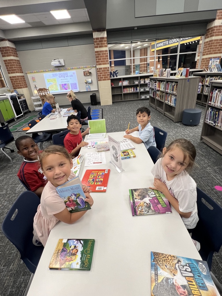 Students Checking holding books in the library