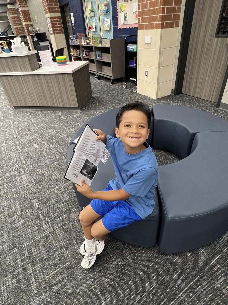 Students Checking holding books in the library