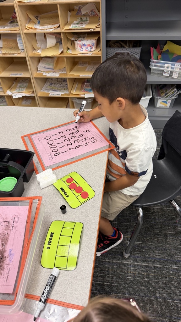 Kinder students at math stations 