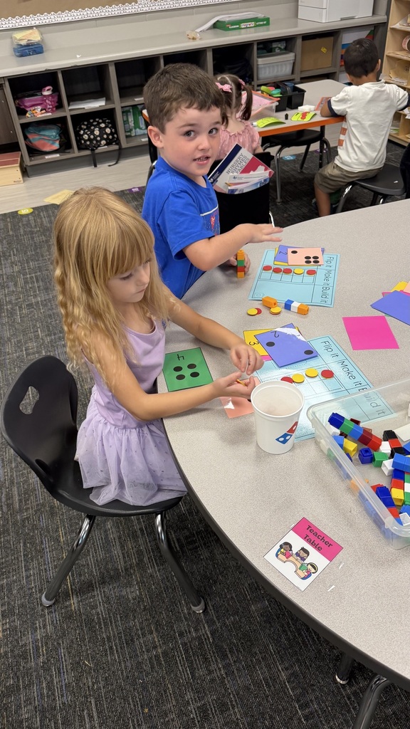 Kinder students at math stations 