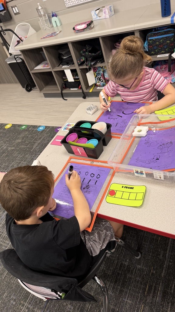 Kinder students at math stations 