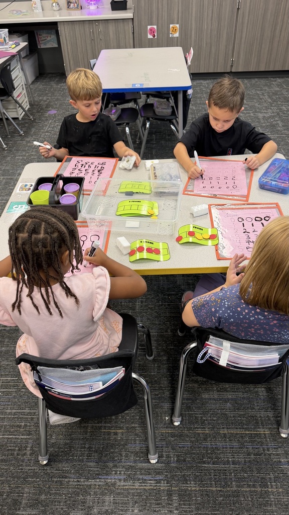 Kinder students at math stations 