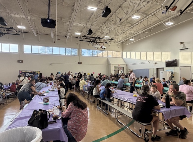 wide view of Creighton Elementary cafeteria filled with grandparents for goodies with grandparents event.