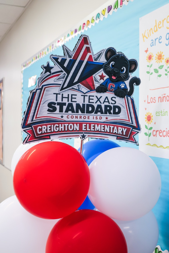 Close-up of a red, white, and blue balloon display topped with a “The Texas Standard – Conroe ISD – Creighton Elementary”