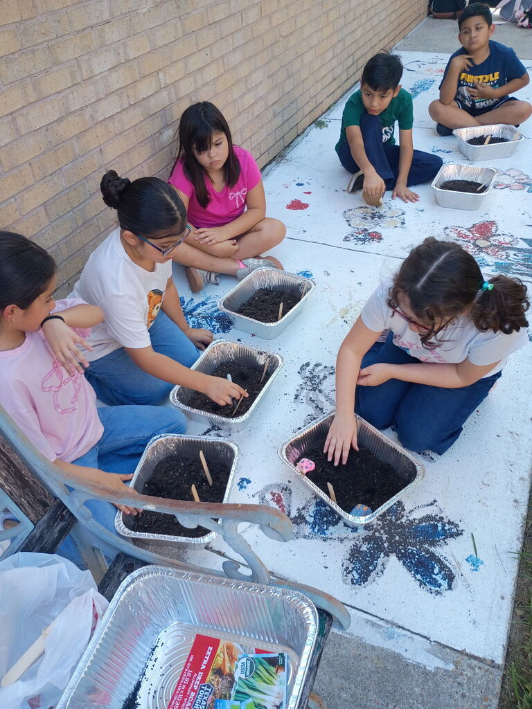 Garden group planting seeds and making their own mini gardens