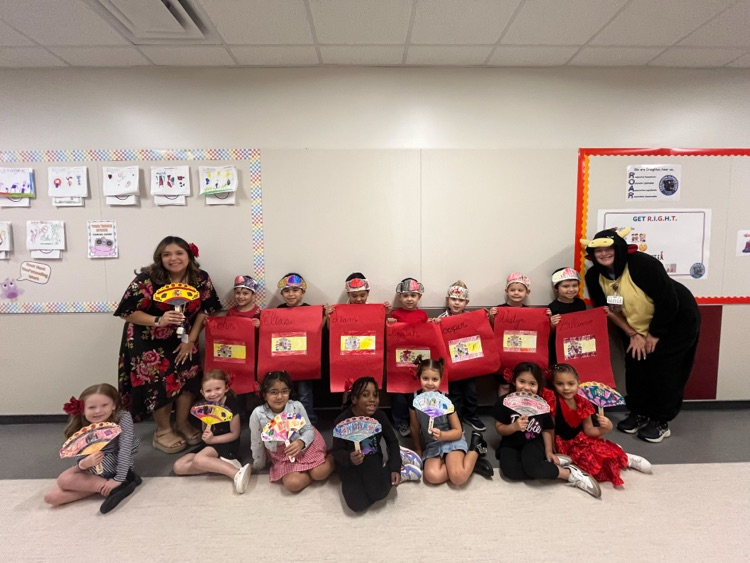 Students and teachers celebrate Hispanic heritage with handmade Spanish flags, colorful fans, and festive attire.