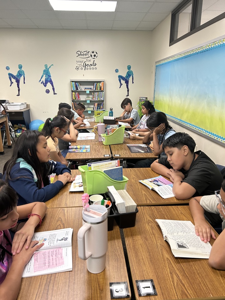 Several students reading at their desks