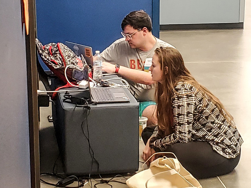 Green works with a debate student at the national tournament.