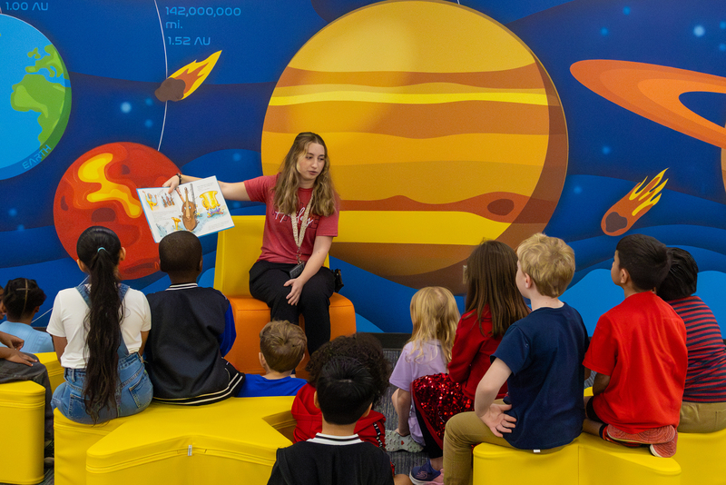 Teacher reading a book to students