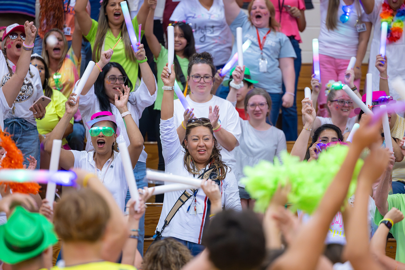 Teachers celebrating at a pep rally