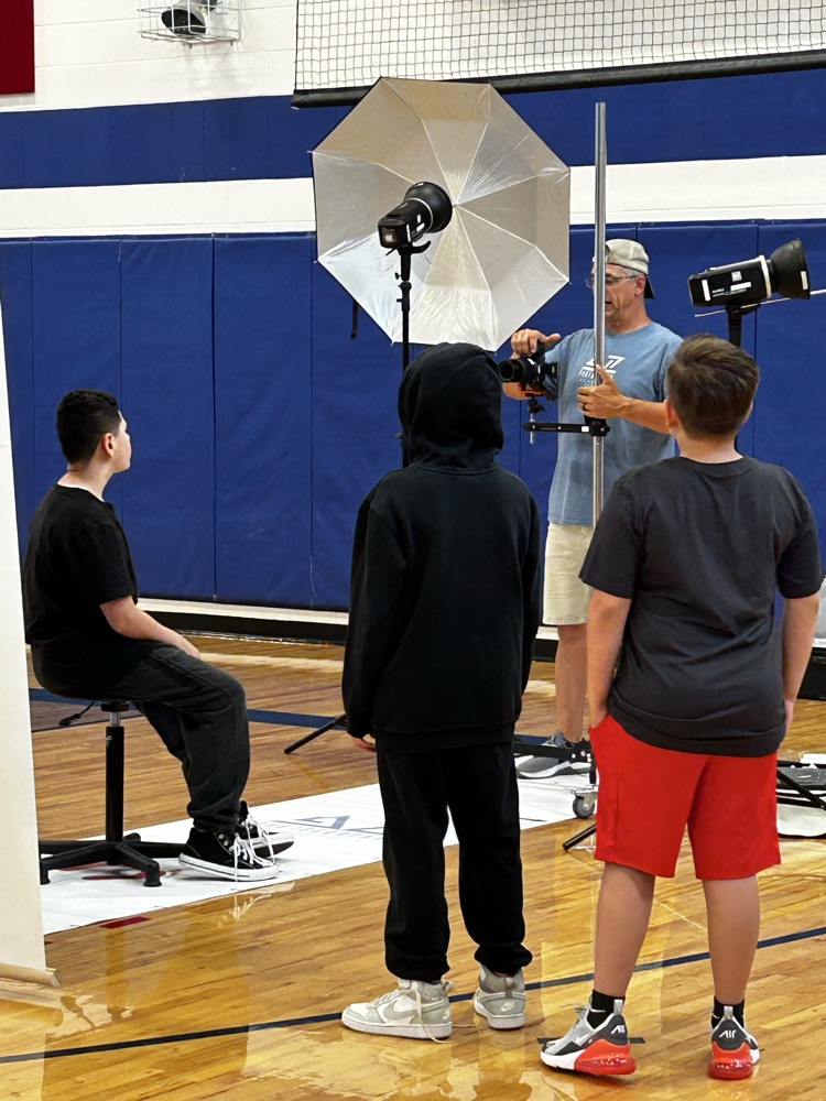 student sitting while getting his picture taken