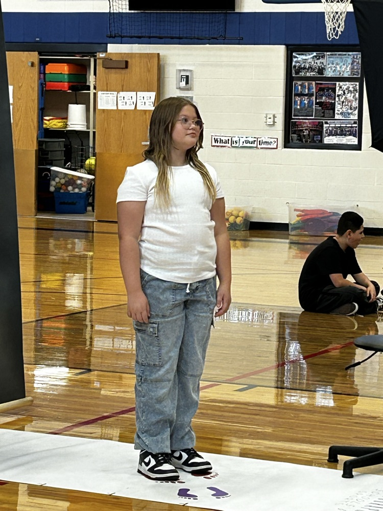 student standing while getting her picture taken