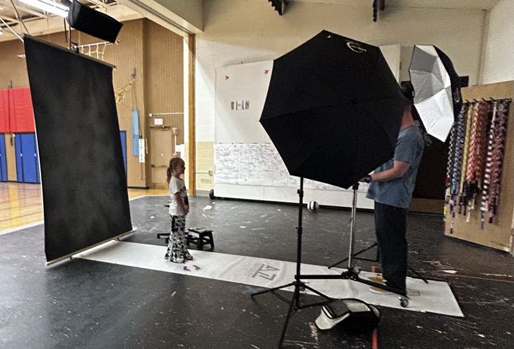 student smiling while getting her picture taken