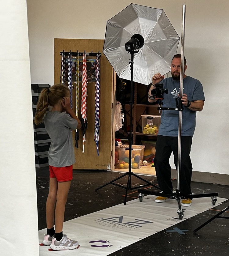 student smiling while getting a picture taken