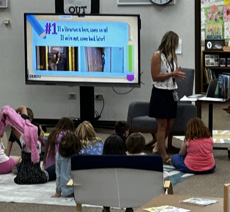 students in front of a Cleartouch board in library class