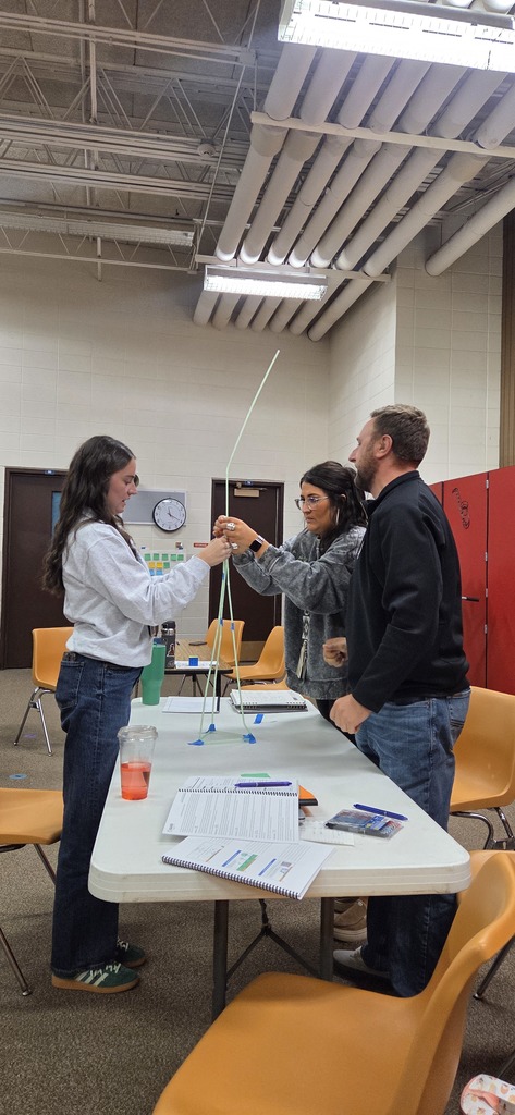 Teachers building a straw tower