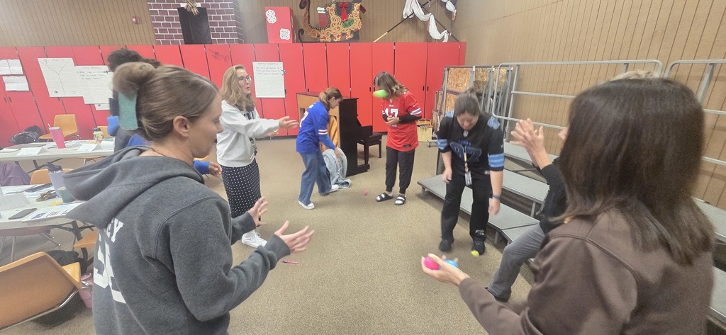 Teachers playing a relationship game with plastic eggs