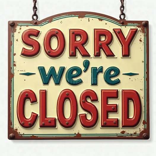 Hanging light yellow and brown sighn with "Sorry we're Closed" in red and green