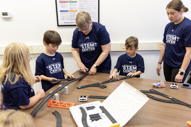 students constructing train track