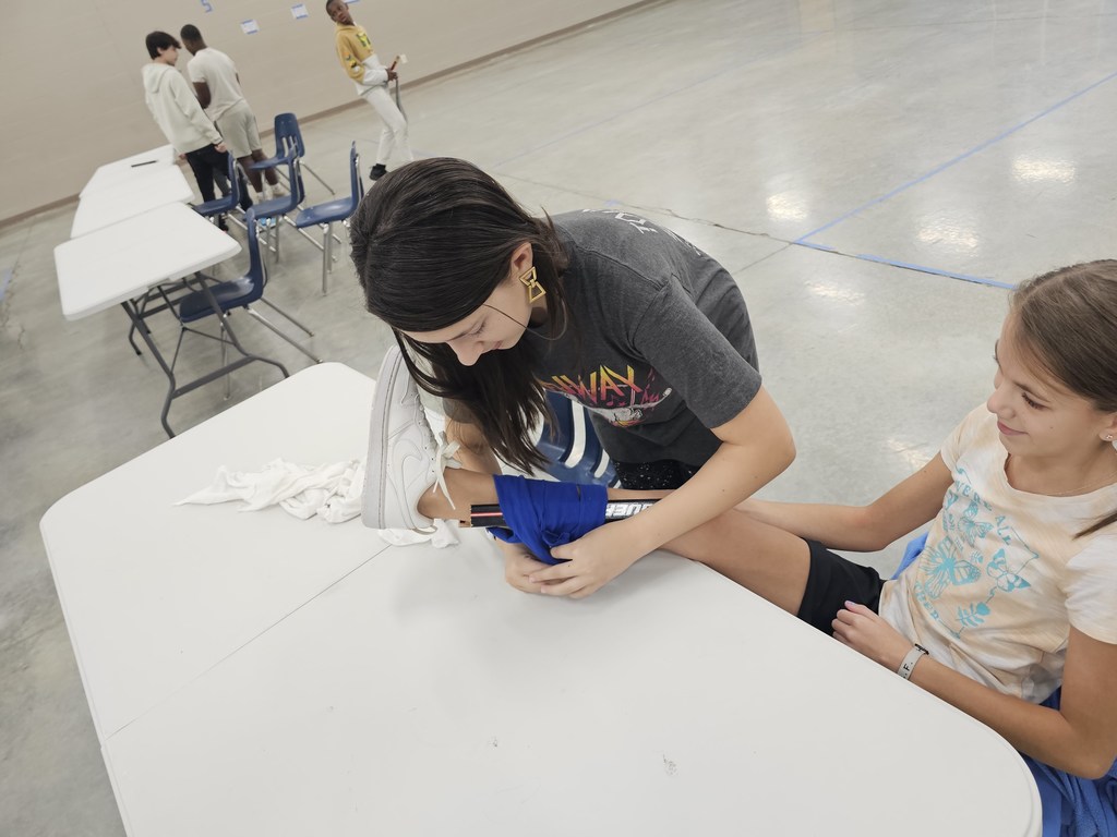Coach German's 7th grade health class learned about basic first aid this week. They practiced creating makeshift slings and braces using cut up T-Shirts and hockey sticks.