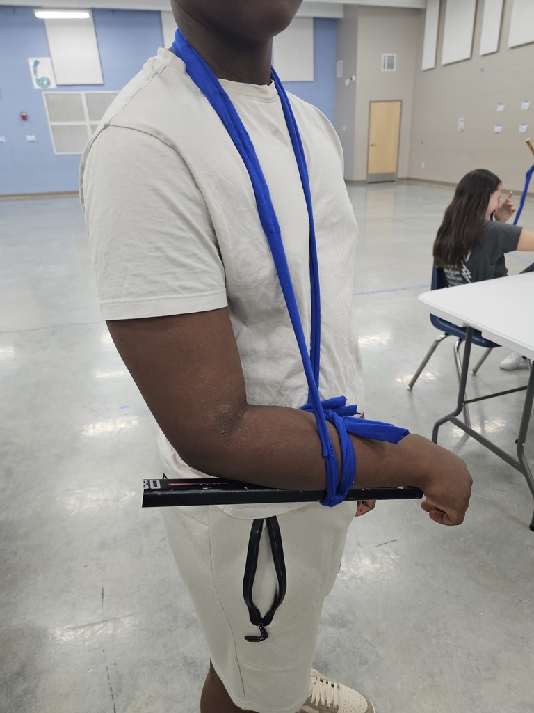 Coach German's 7th grade health class learned about basic first aid this week. They practiced creating makeshift slings and braces using cut up T-Shirts and hockey sticks.