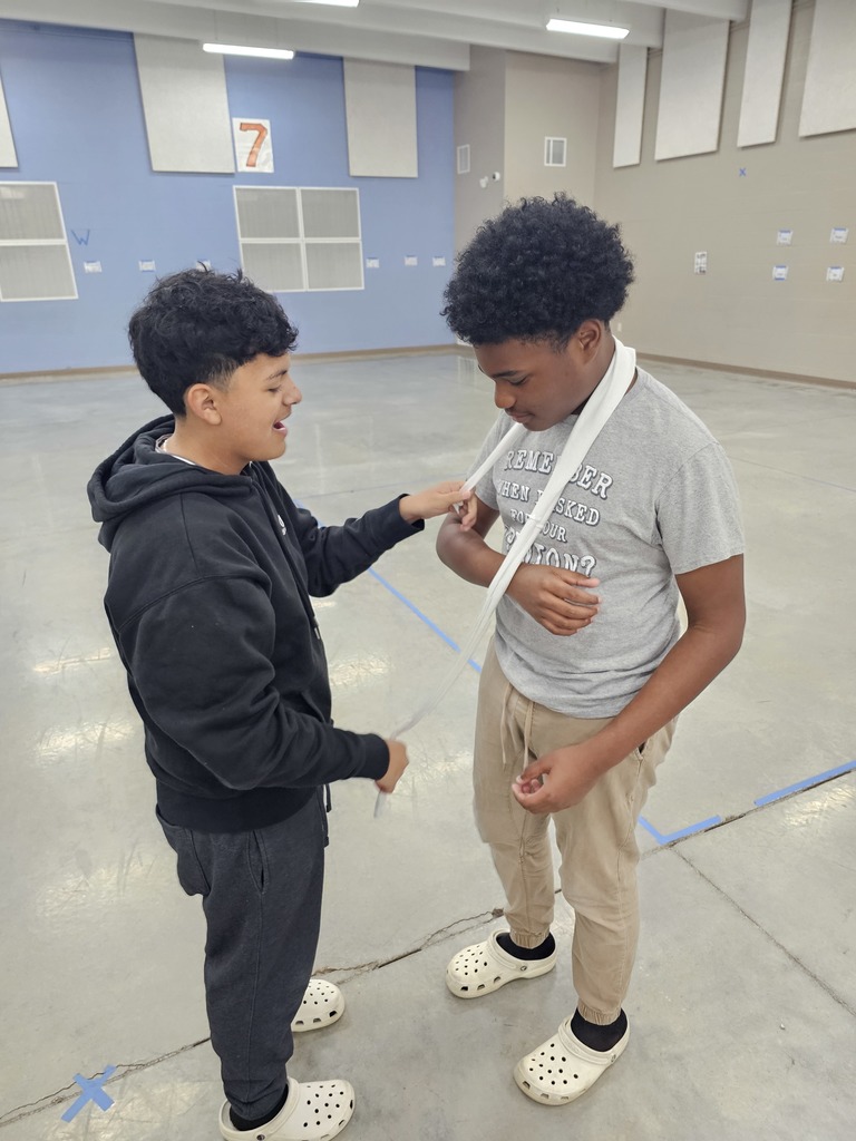 Coach German's 7th grade health class learned about basic first aid this week. They practiced creating makeshift slings and braces using cut up T-Shirts and hockey sticks.