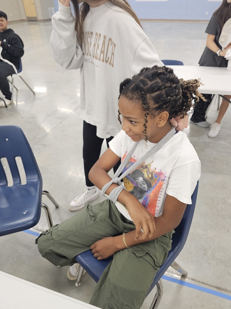 Coach German's 7th grade health class learned about basic first aid this week. They practiced creating makeshift slings and braces using cut up T-Shirts and hockey sticks.