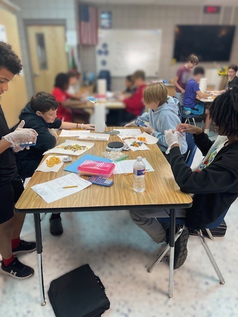 Mrs. Hunter's 7th Accelerated Sciences have been working with physical properties this week as they determined mass, volume, density, circumference, and height as they worked with some yummy and seasonal items. This was an opportunity for the students to demonstrate what they have learned during their Chemistry unit. Fun and great snacks were had by