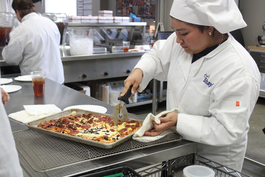 Student making pizza