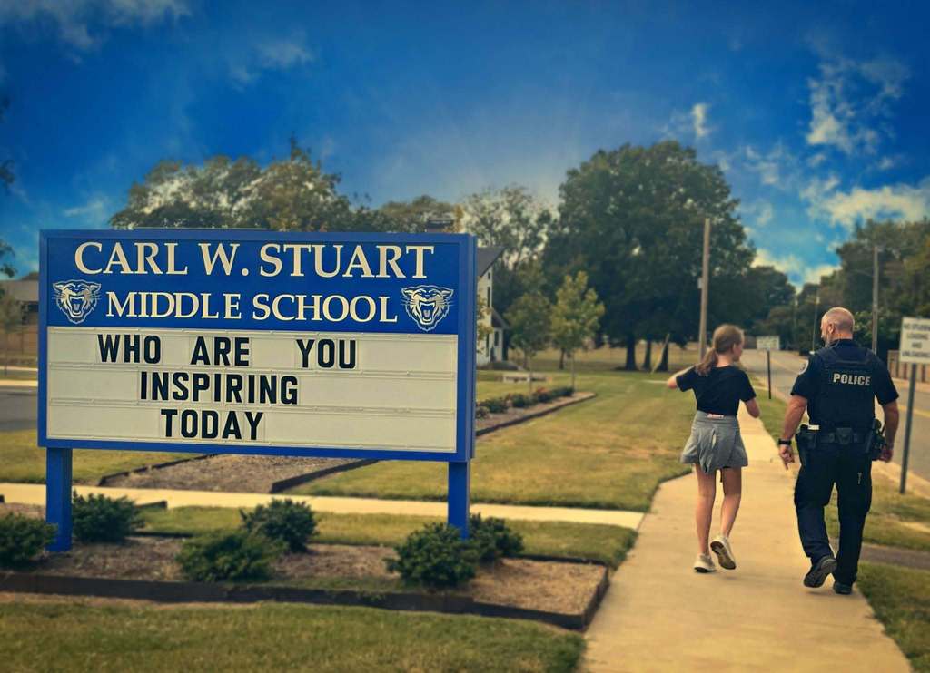 Officer Slayton walking with student