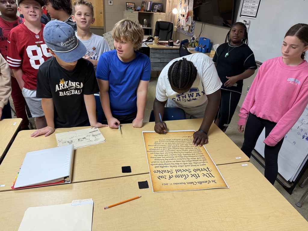 students signing posters