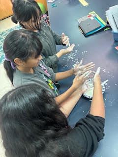 Students making Oobleck (green slime) in science class