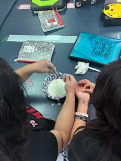 Students making Oobleck (green slime) in science class