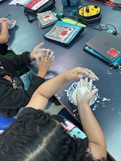 Students making Oobleck (green slime) in science class