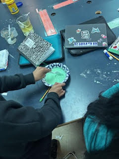 Students making Oobleck (green slime) in science class